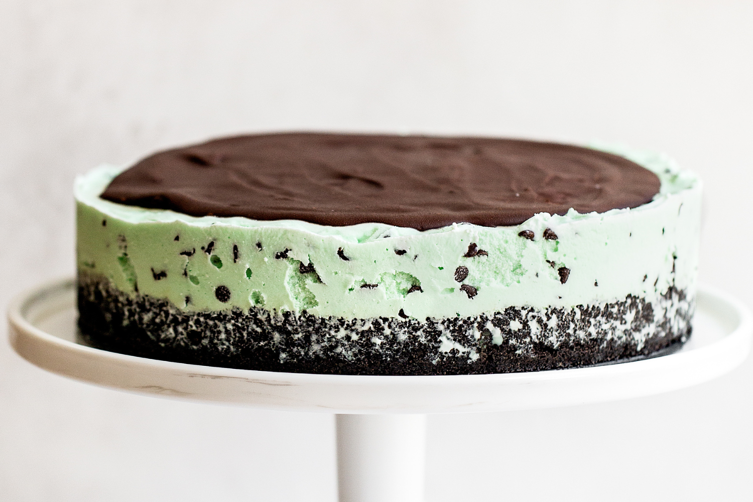 whole Frozen Mint Chocolate Chip Pie on a cake stand.