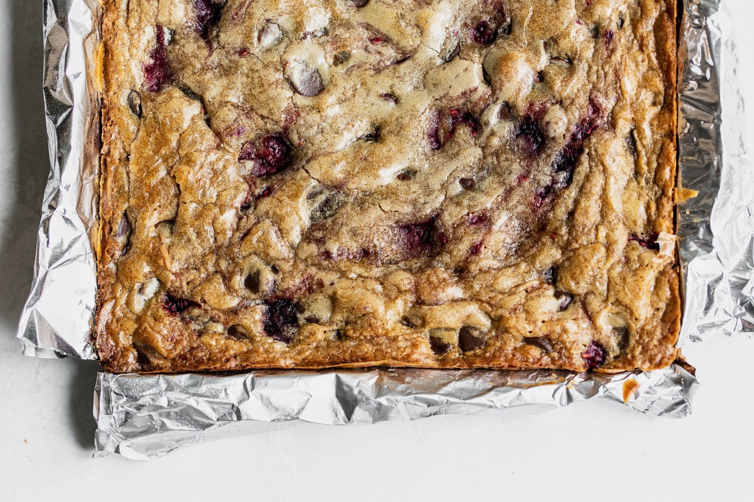 unsliced full slab of raspberry blondies.