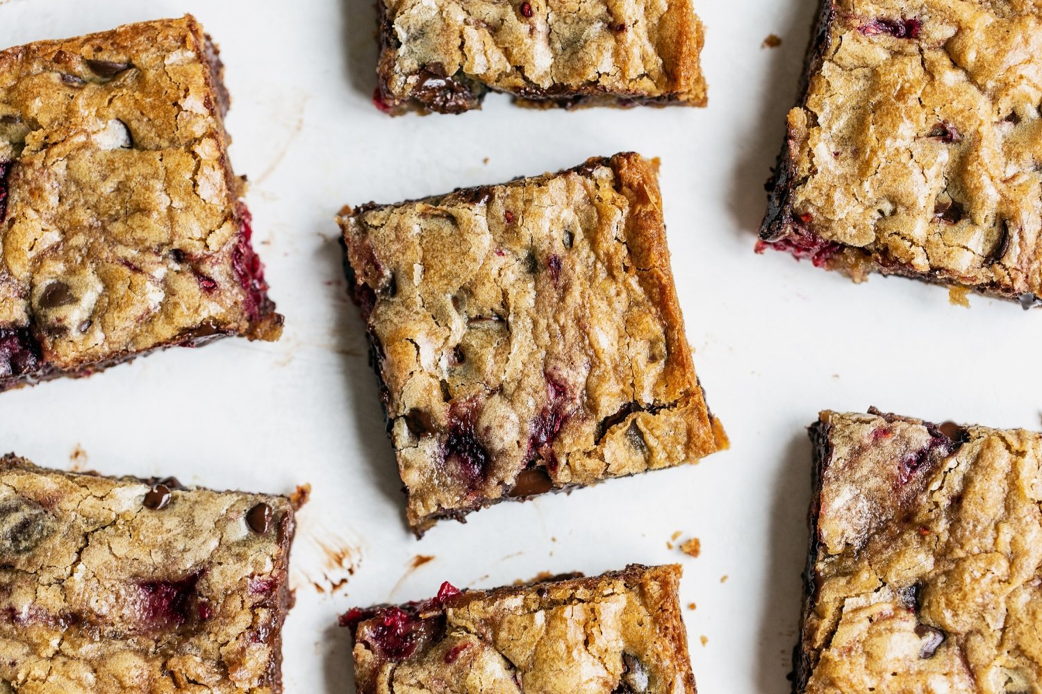 slices of blondies scattered on a white background.
