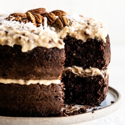 german chocolate cake on a plate with a slice being removed.