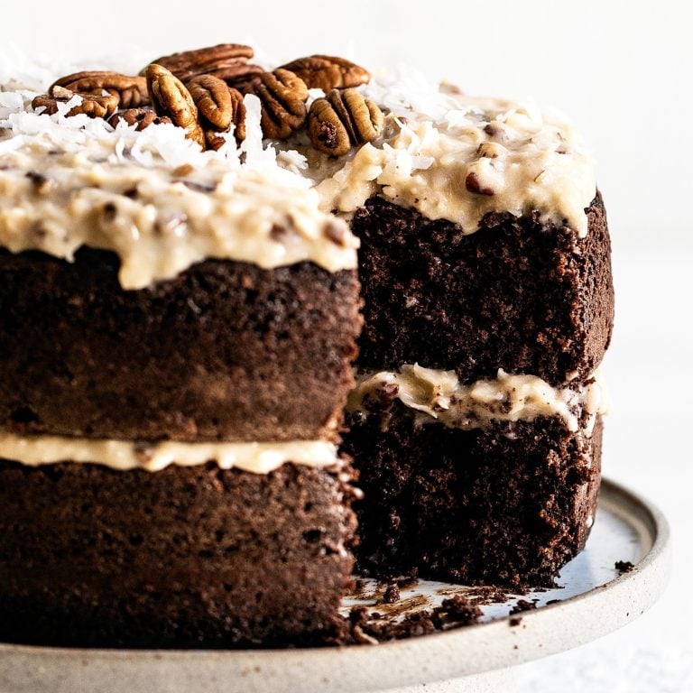 german chocolate cake on a plate with a slice being removed.
