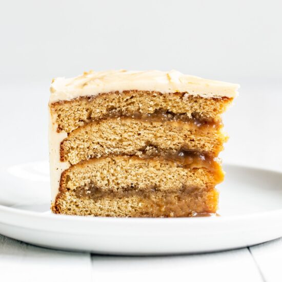 Slice of Butterscotch layer cake with butterscotch sauce filling and buttercream on top