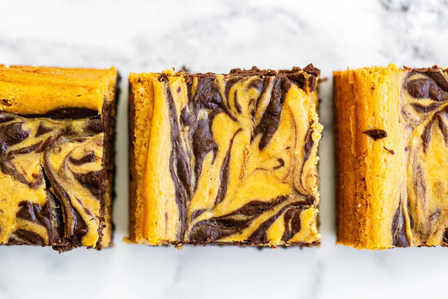 pumpkin cheesecake bars from above, showing their pretty marble effect 
