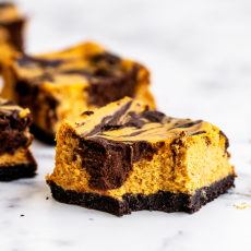 a slice of pumpkin chocolate cheesecake with a bite taken out