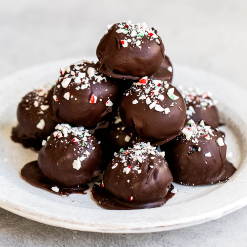 a pile of Peppermint Oreo Truffles on a plate, ready to serve.