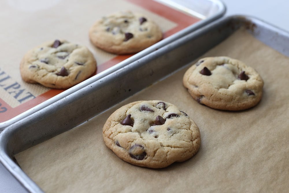 Four cookies side by side to compare silpat vs parchment paper