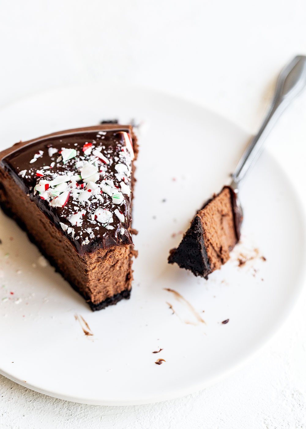 Slice of chocolate peppermint cheesecake with a bite removed