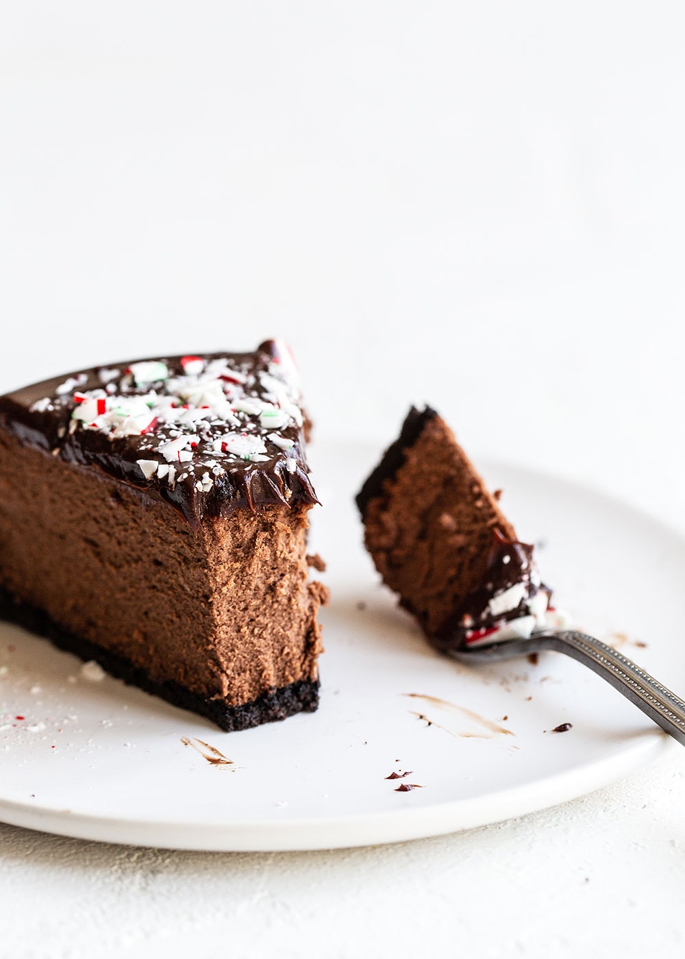 Tall and creamy slice of Christmas Chocolate Peppermint Cheesecake