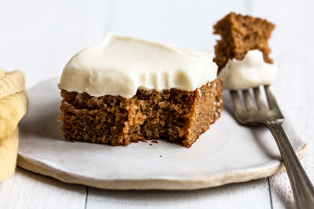 Slice of gingerbread sheet cake with a bite removed