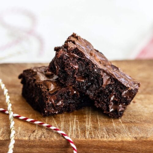 Gooey fudgy ginger brownies on a wooden cutting board