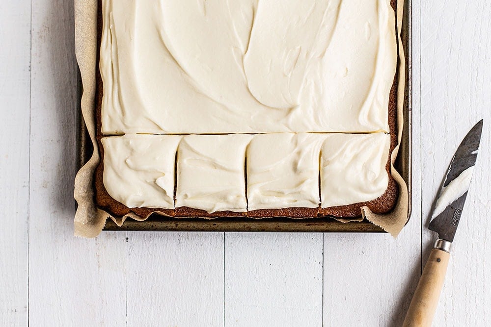 Gingerbread sheet cake in a baking pan with slices cut ready to serve