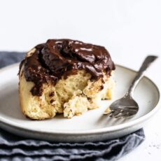 Gooey chocolate swirl roll on a plate with a fork
