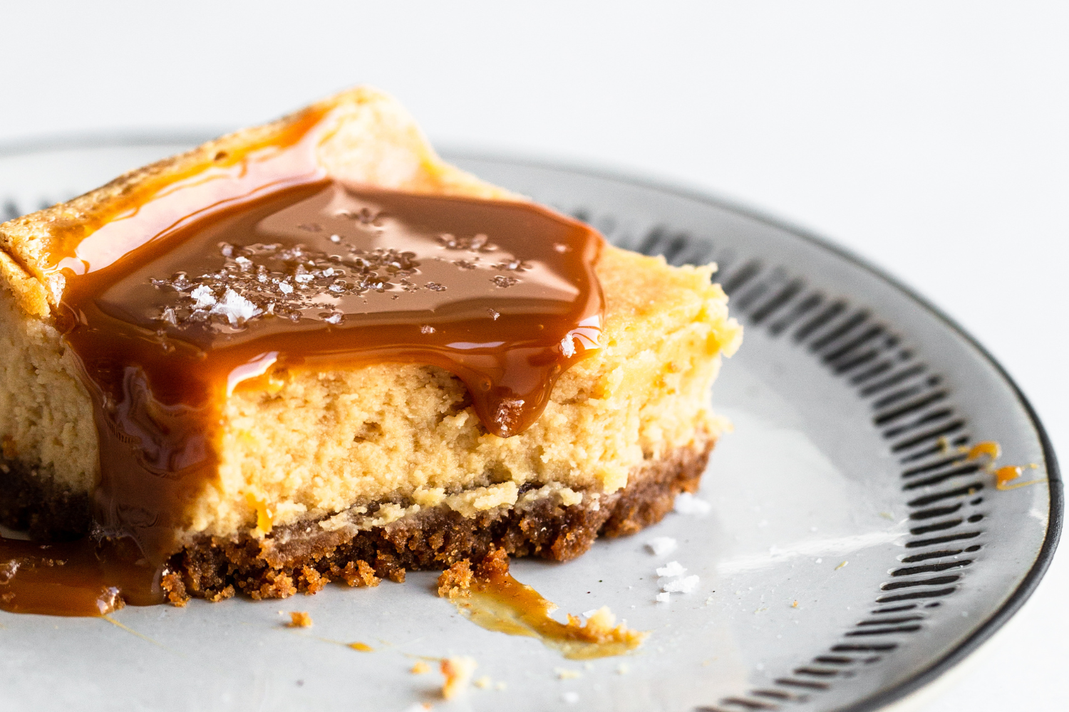 a slice of caramel cheesecake bar on a plate
