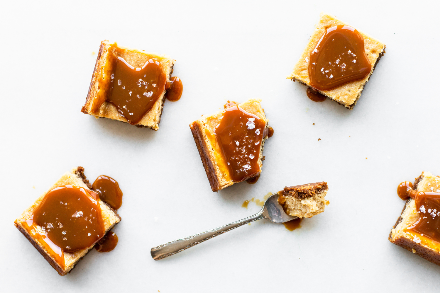slices of salted caramel cheesecake, covered in salted caramel sauce