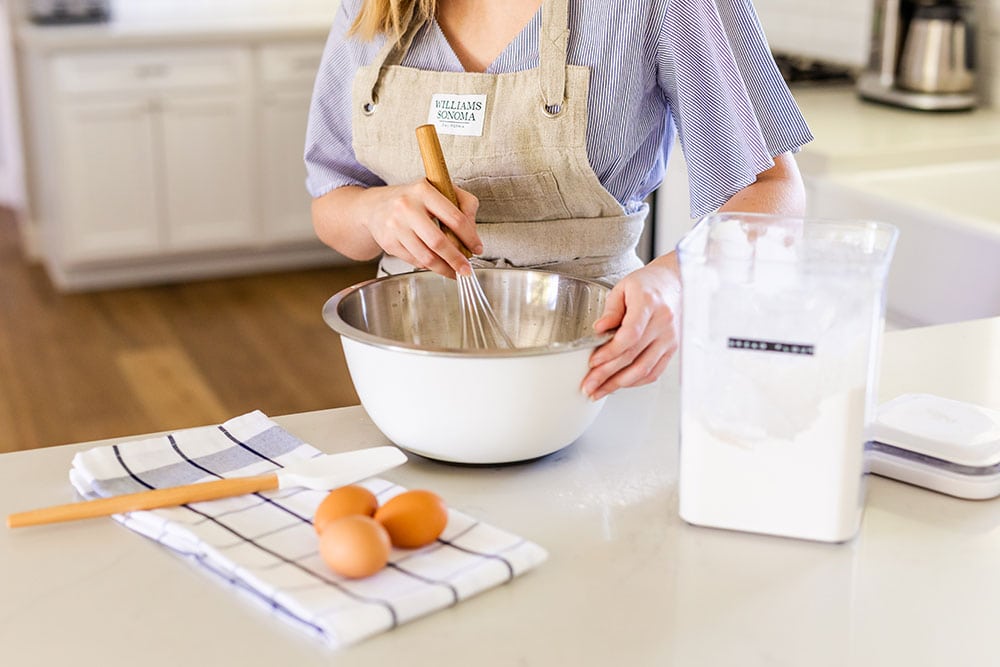 Tessa Arias in the kitchen with a mixing bowl baking