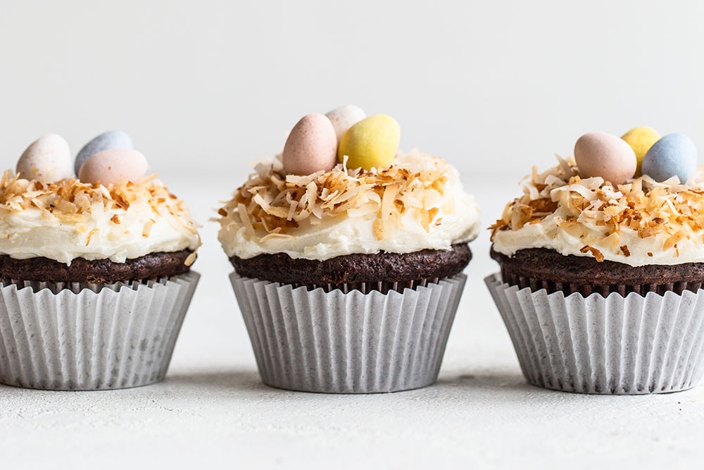 Row of three chocolate coconut Easter cupcakes