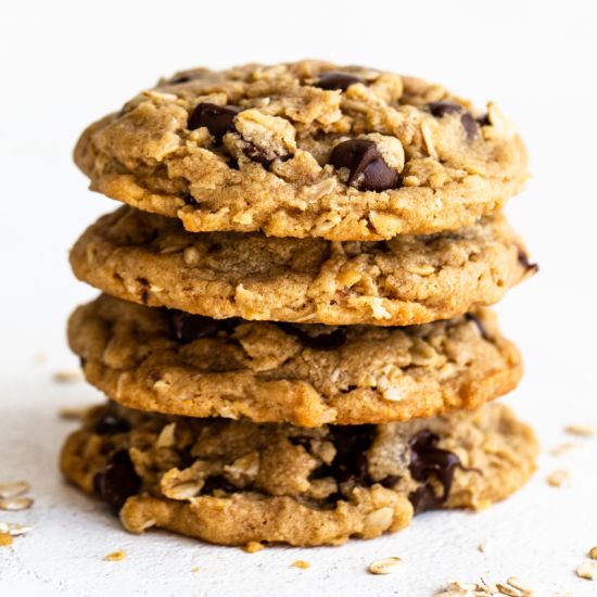 a stack of thick peanut butter oatmeal chocolate chip cookies