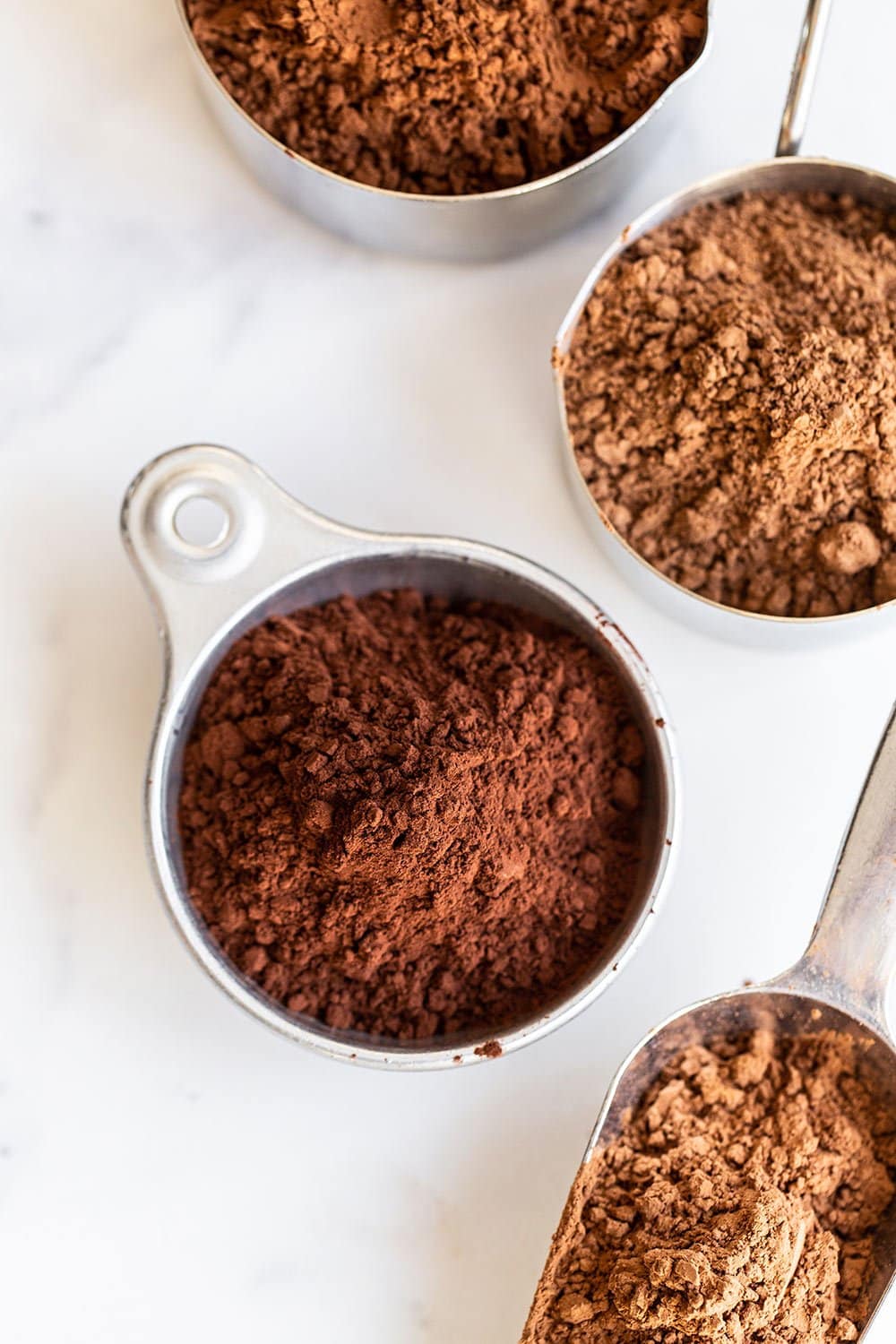 different types of cocoa powder in measuring cups