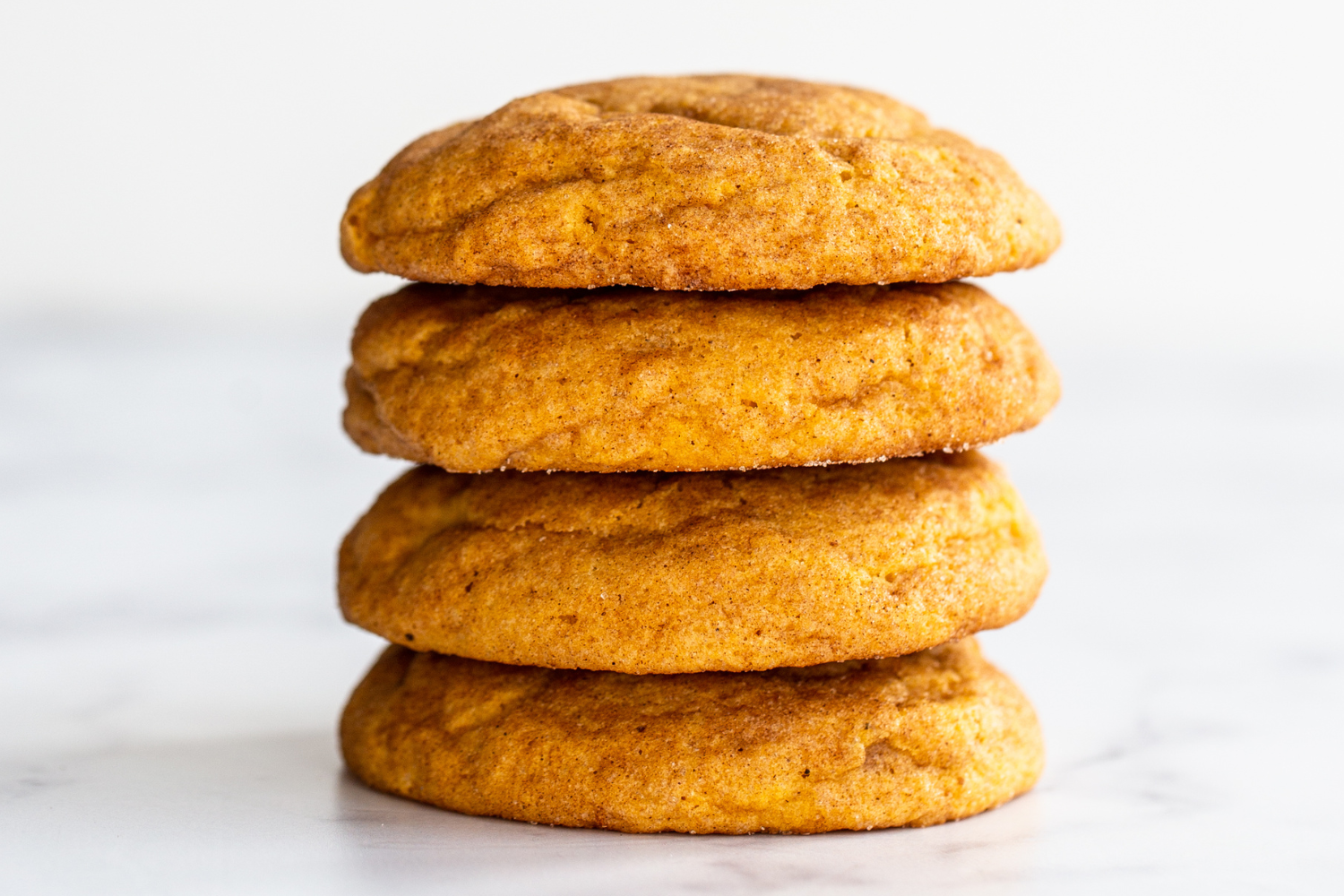 Pumpkin Snickerdoodles stacked 4 high to show how thick they are.