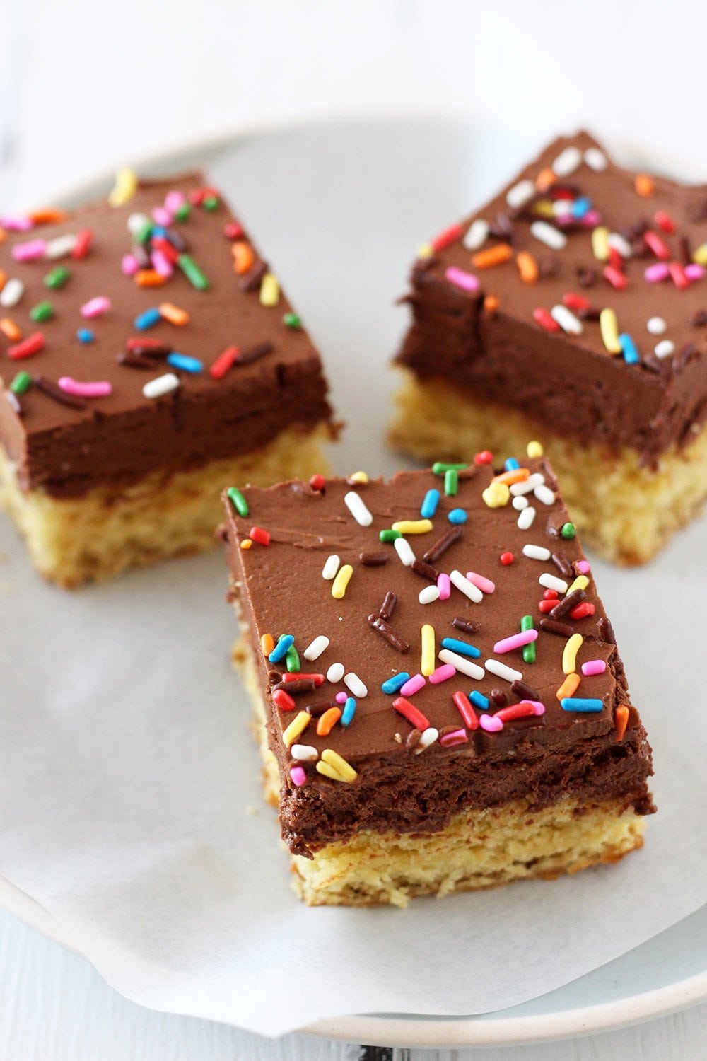 chocolate frosted sugar cookie bars with sprinkles on top