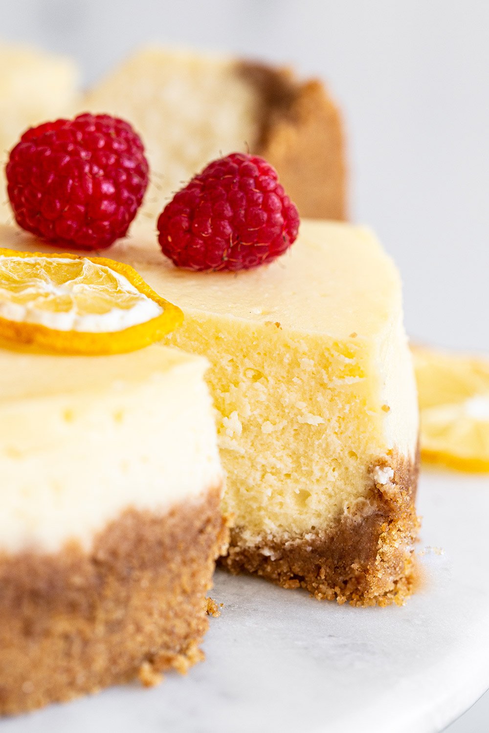 slice of rich classic cheesecake with fruit garnished on top