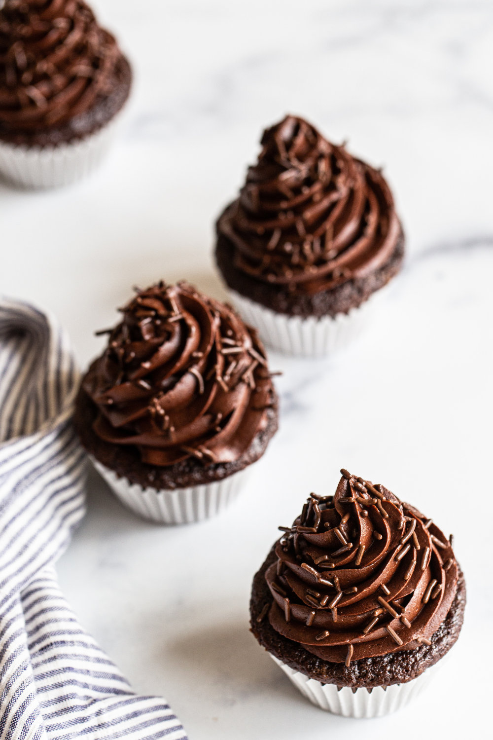best ever chocolate cupcakes with chocolate frosting on a white background