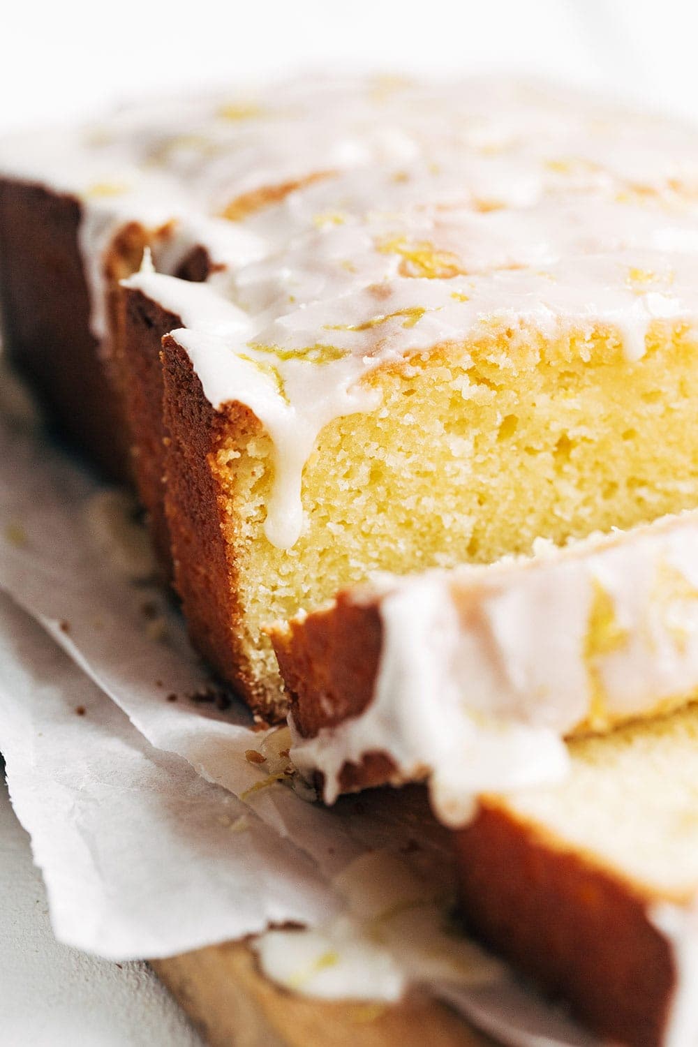 close up of copycat starbucks lemon pound cake with icing dripping