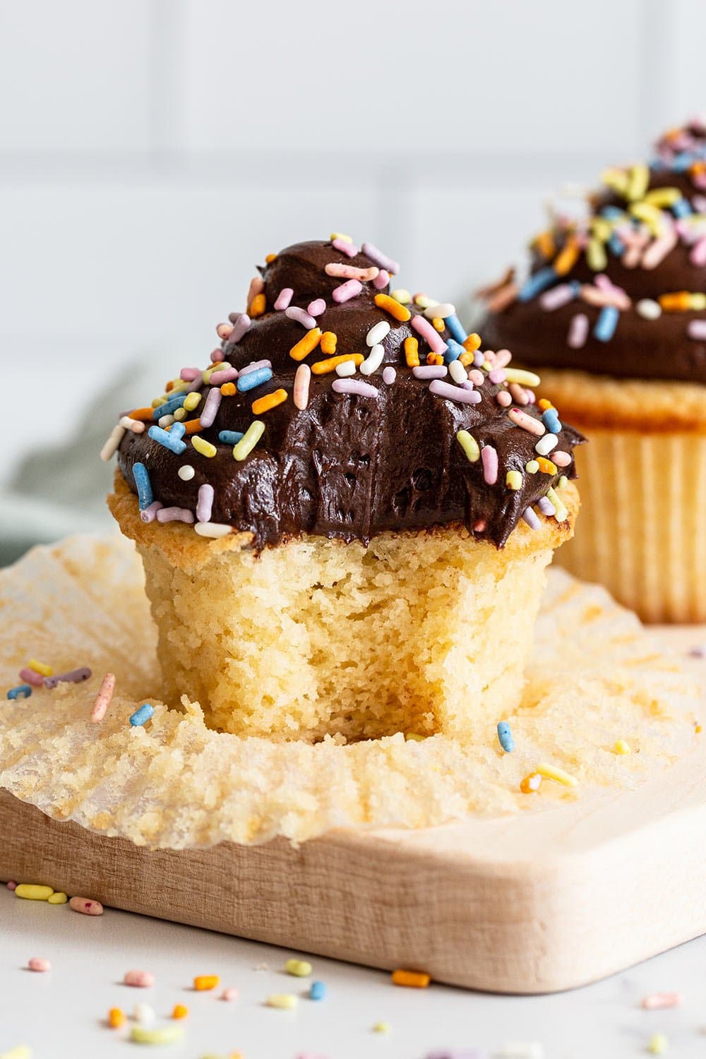 best yellow cupcakes with chocolate buttercream with bite taken out