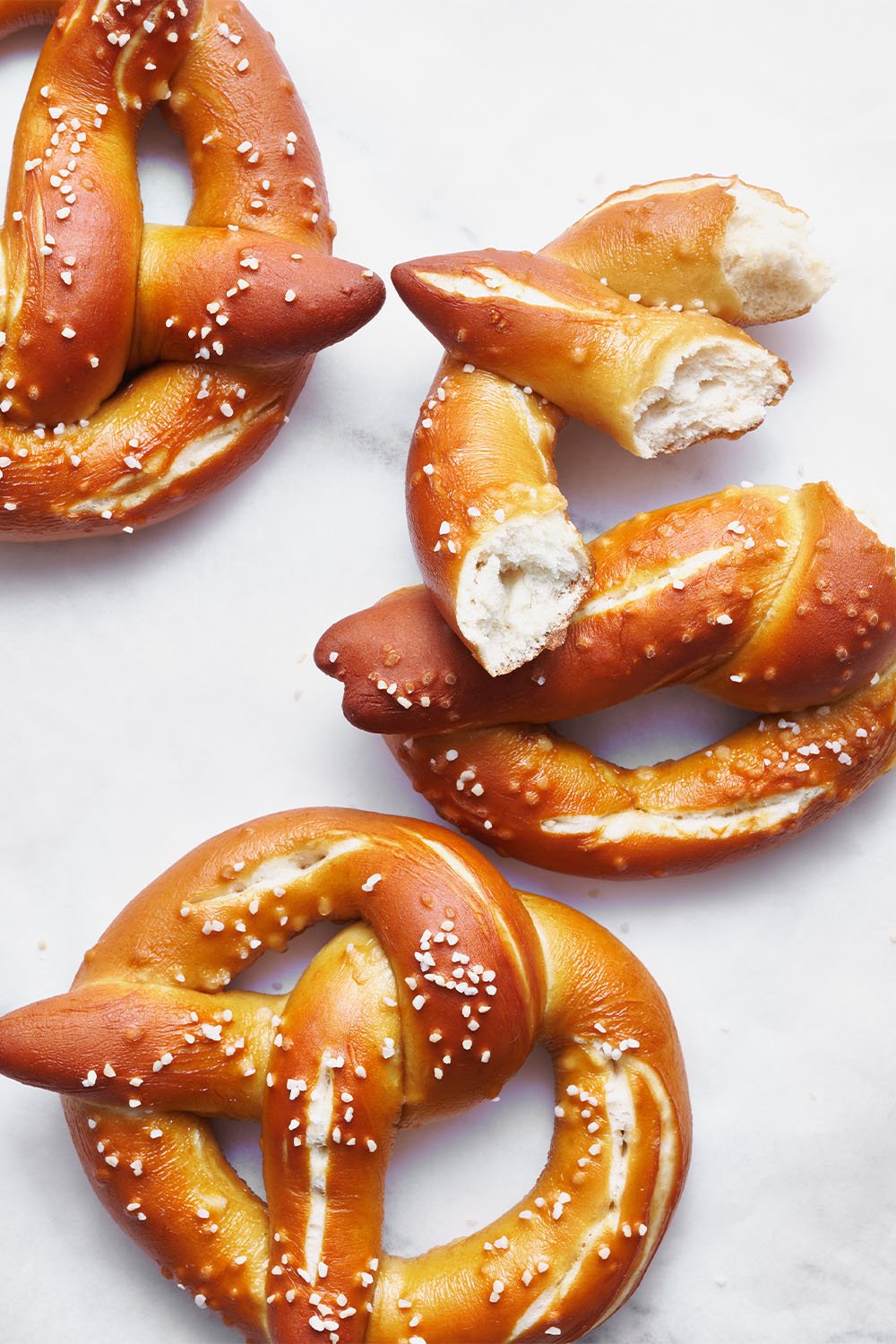 homemade Bavarian-style pretzels on a marble background