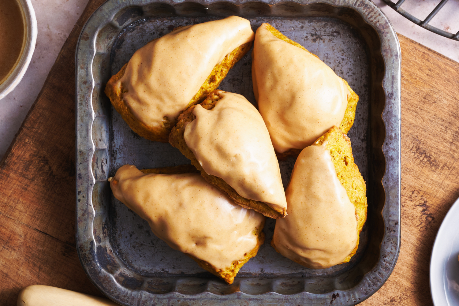 perfect pumpkin scones with pumpkin spice glaze, on a platter, ready to serve