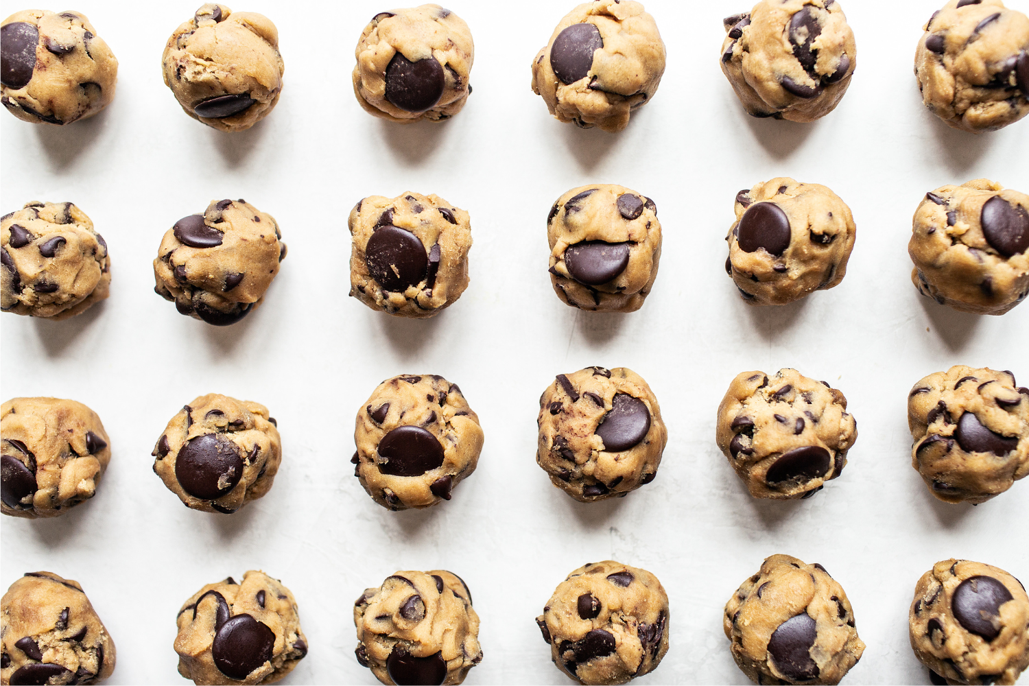 a batch of Brown Butter Chocolate Chip Cookie dough balls, ready to bake