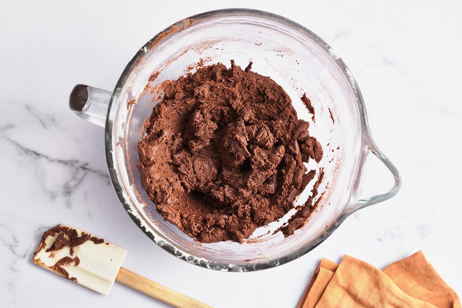 stand mixer bowl filled with chocolate sugar cookie dough, ready to roll, cut and bake