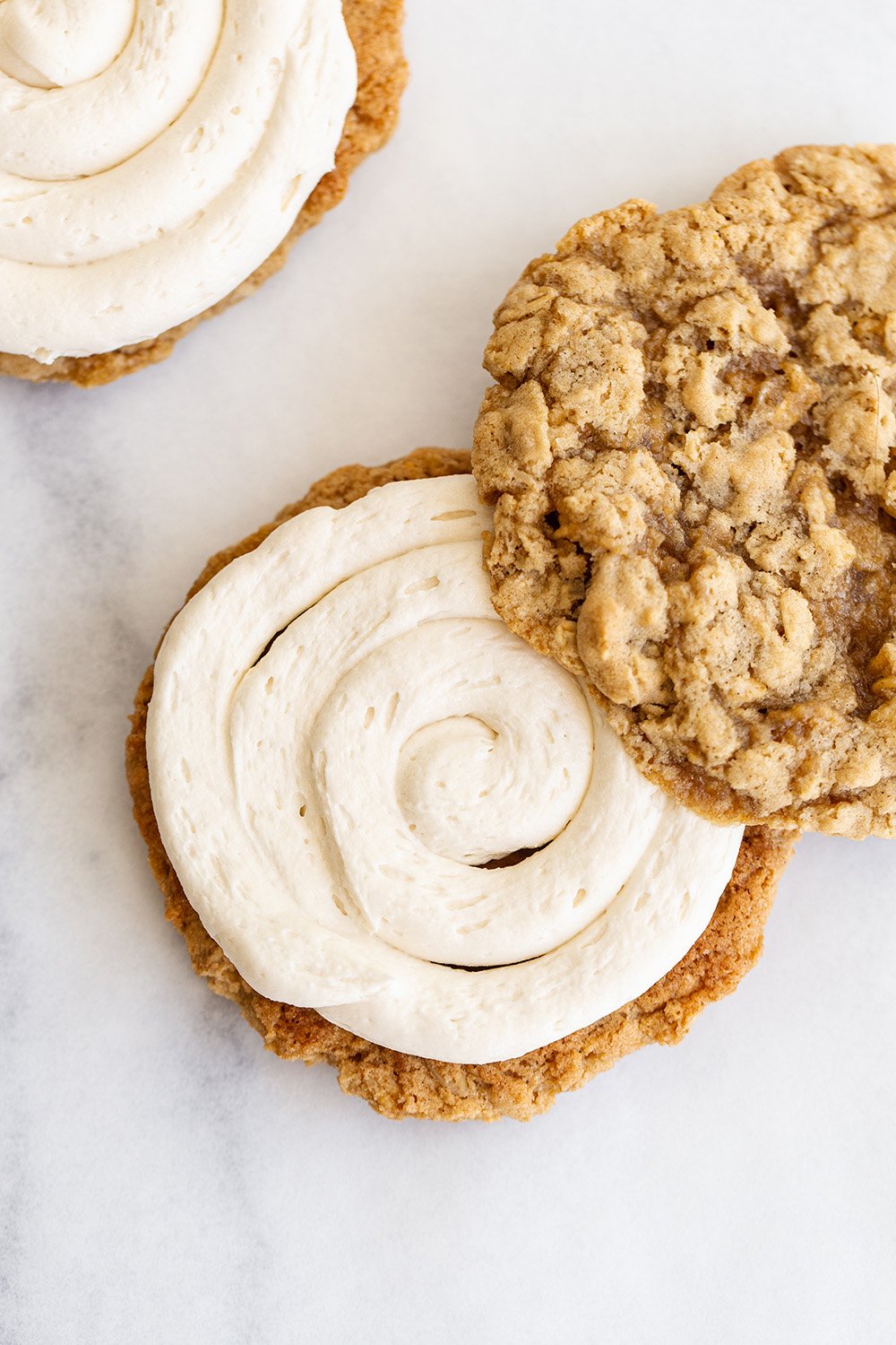 oatmeal cookies being sandwiched to form oatmeal cream pies.