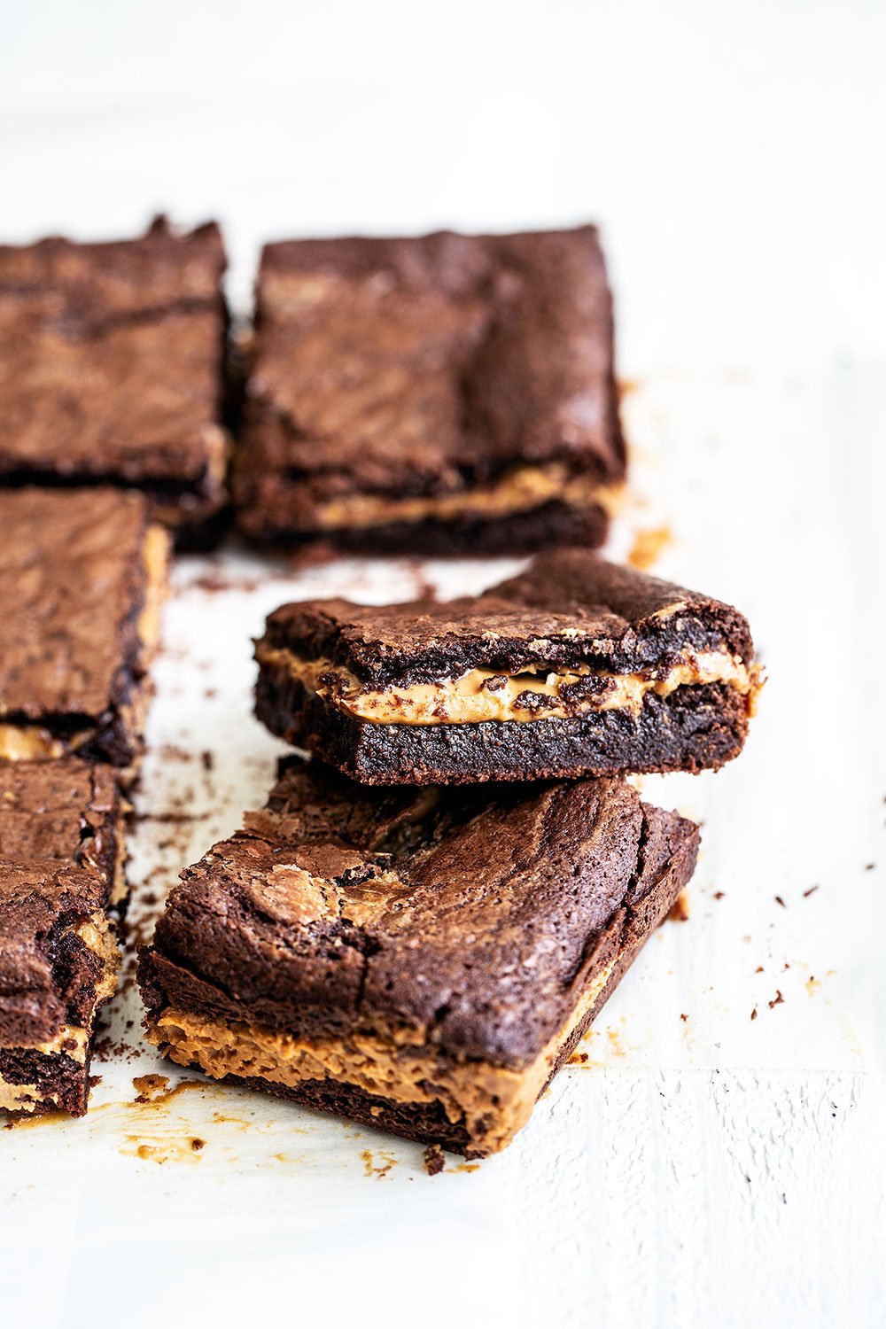 Easy peanut butter filled chocolate brownies cut into squares and stacked on top of each other