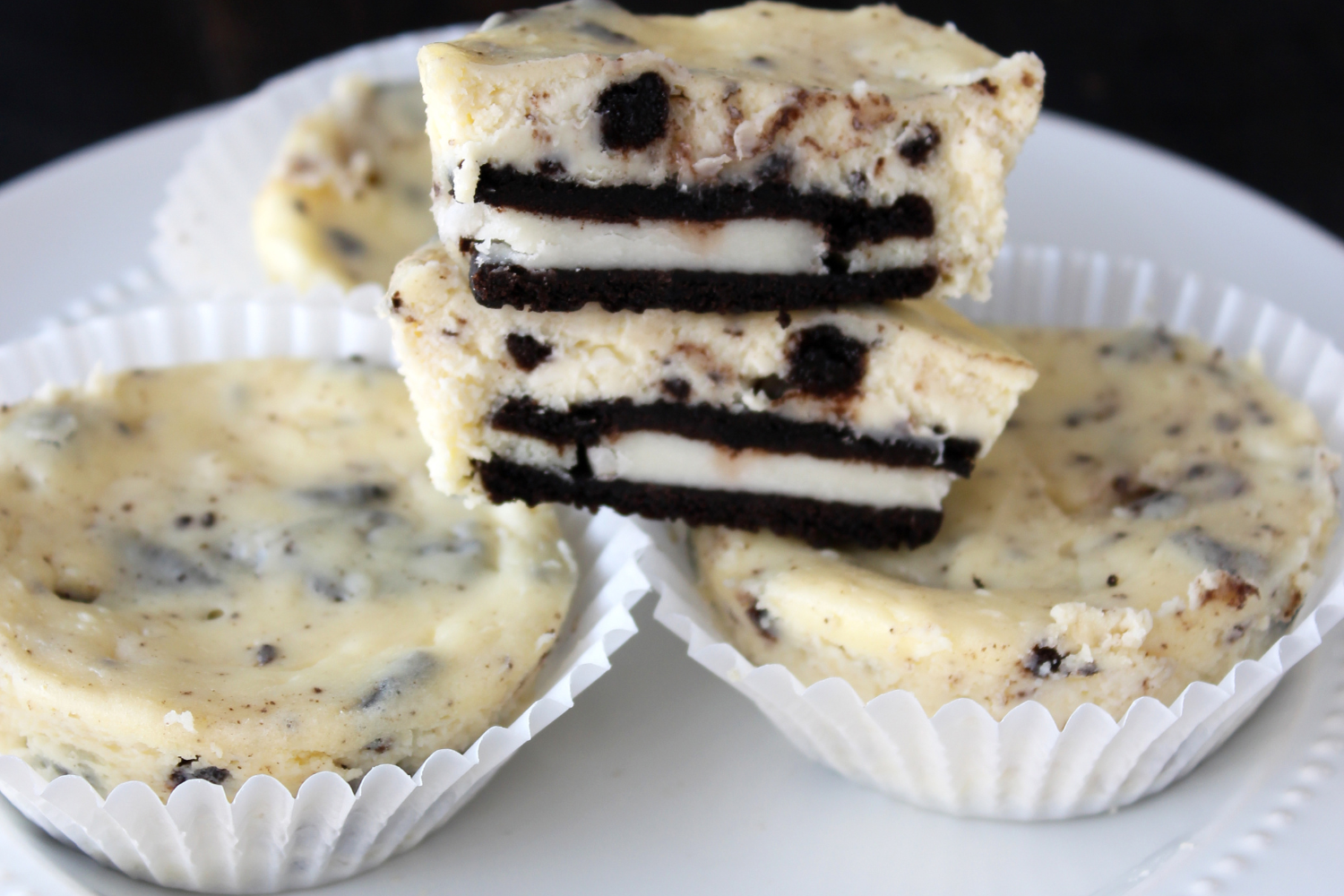 mini cookies and cream cheesecakes on a white plate