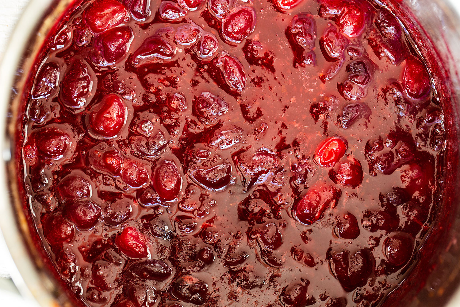 closeup of this cranberry sauce, with some whole berries and orange zest visible.