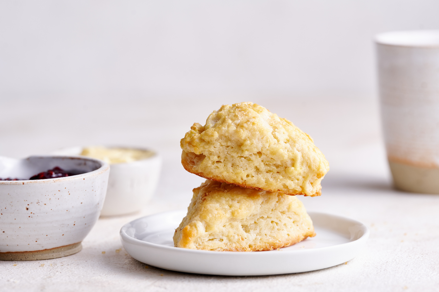 two tall scones sitting on a white plate.