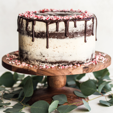 chocolate cake lightly iced in peppermint buttercream, with a chocolate ganache drip, topped with crushed candy canes.
