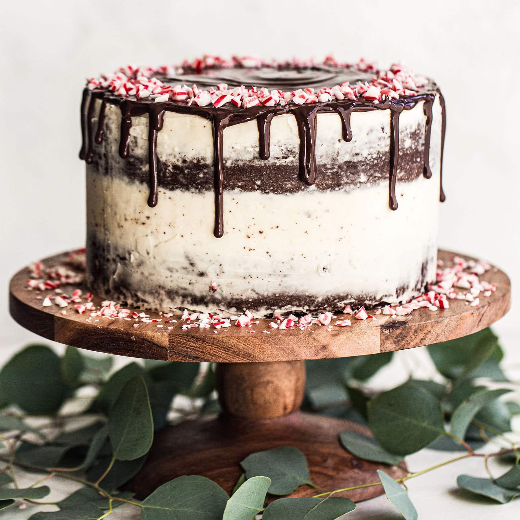 peppermint chocolate cake with buttercream and chocolate drip on a cake stand