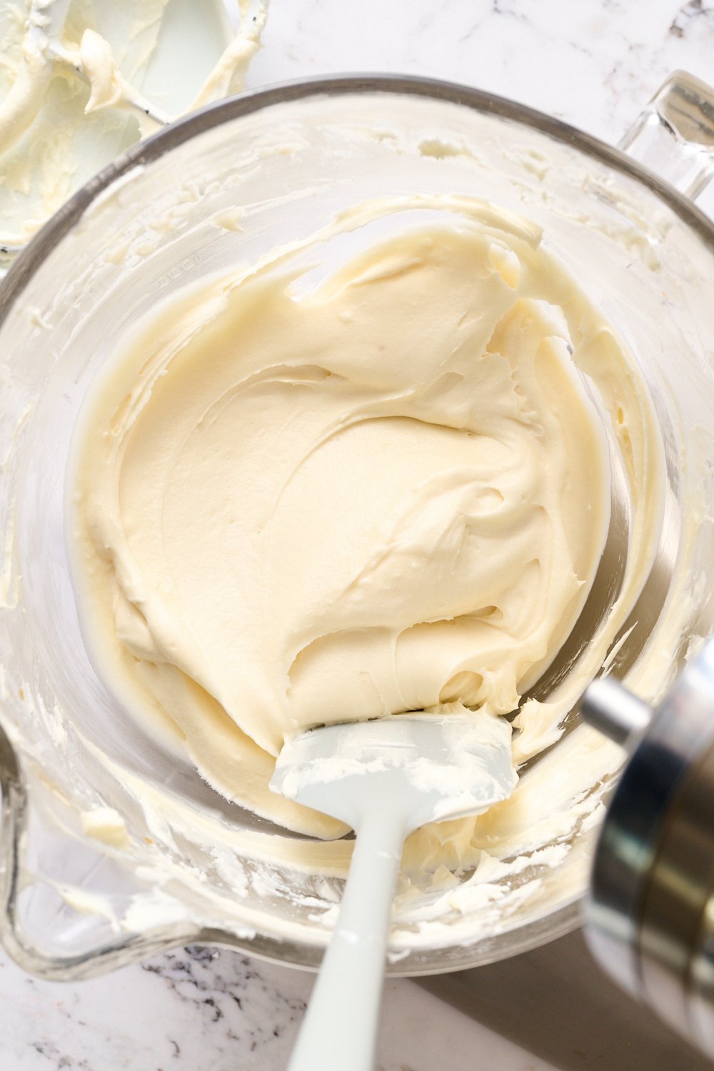 a bowl of silky-smooth, creamy cream cheese frosting.