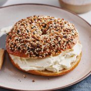 homemade new york style bagel with cream cheese on a plate
