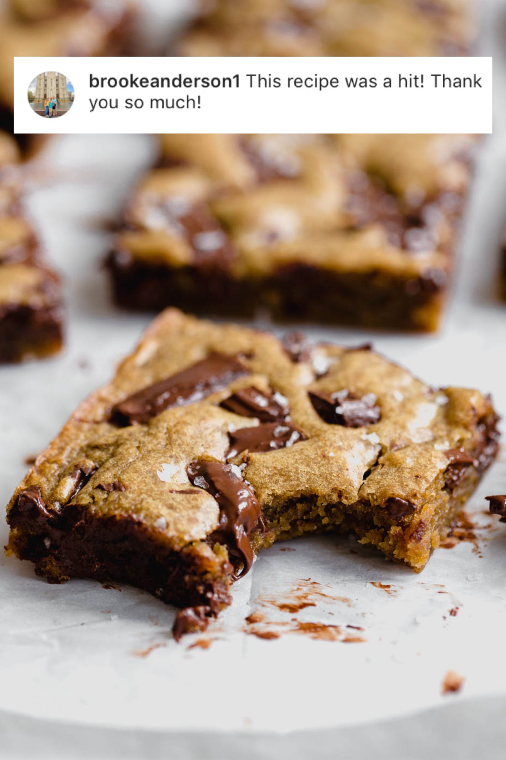 Gooey Chocolate Chunk Blondies with a bite taken out of one. Heavenly easy dessert recipe.