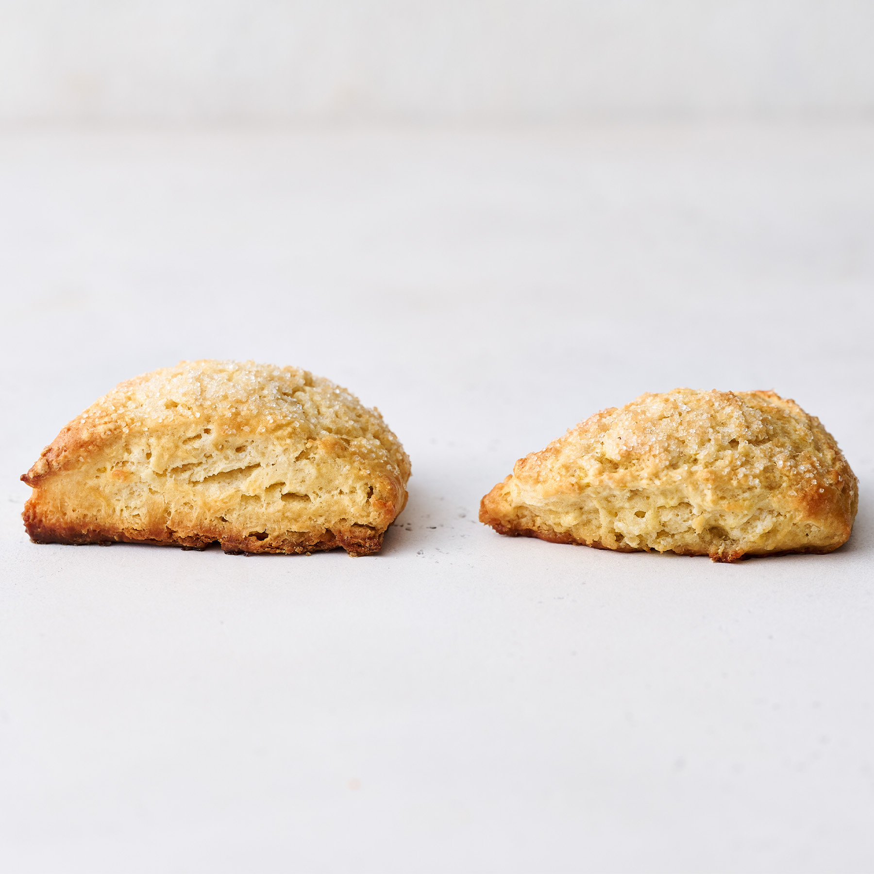 tall scones vs flat scones on a white background.