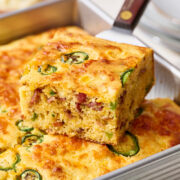 slice of jalapeno cheddar cornbread being lifted from pan