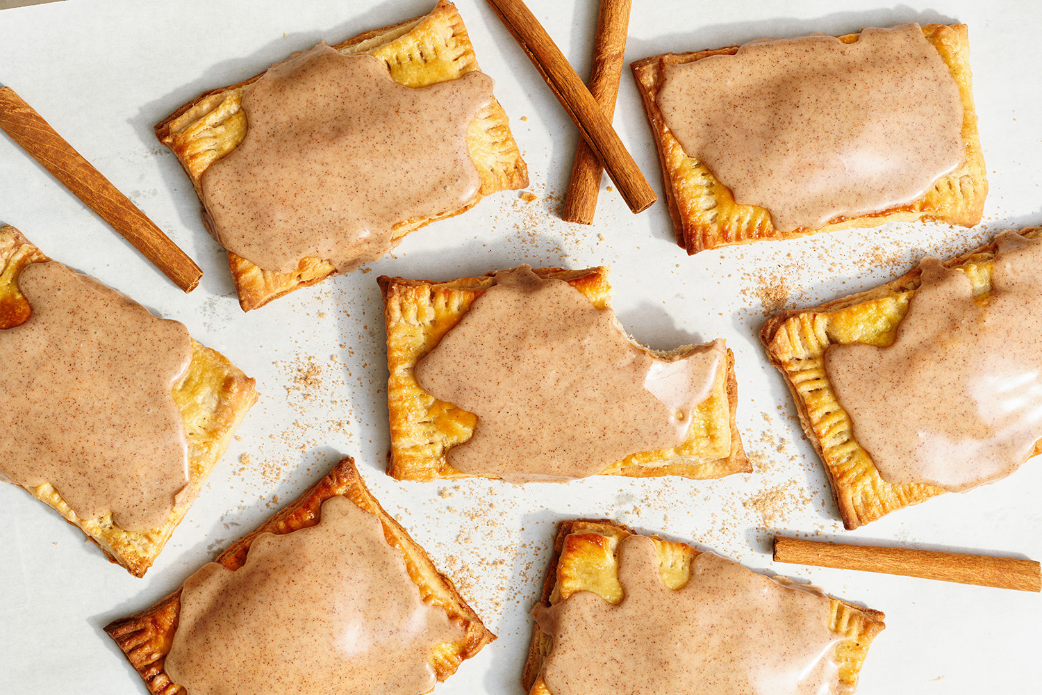 several glazed Pop Tarts with some cinnamon sticks between, ready to be served.