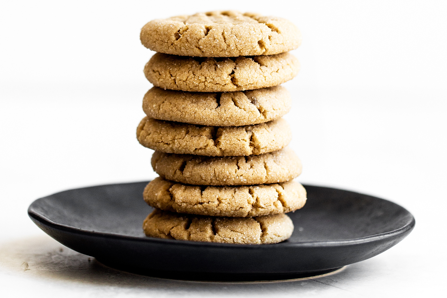 stack of thick, chewy peanut butter cookies on a plate