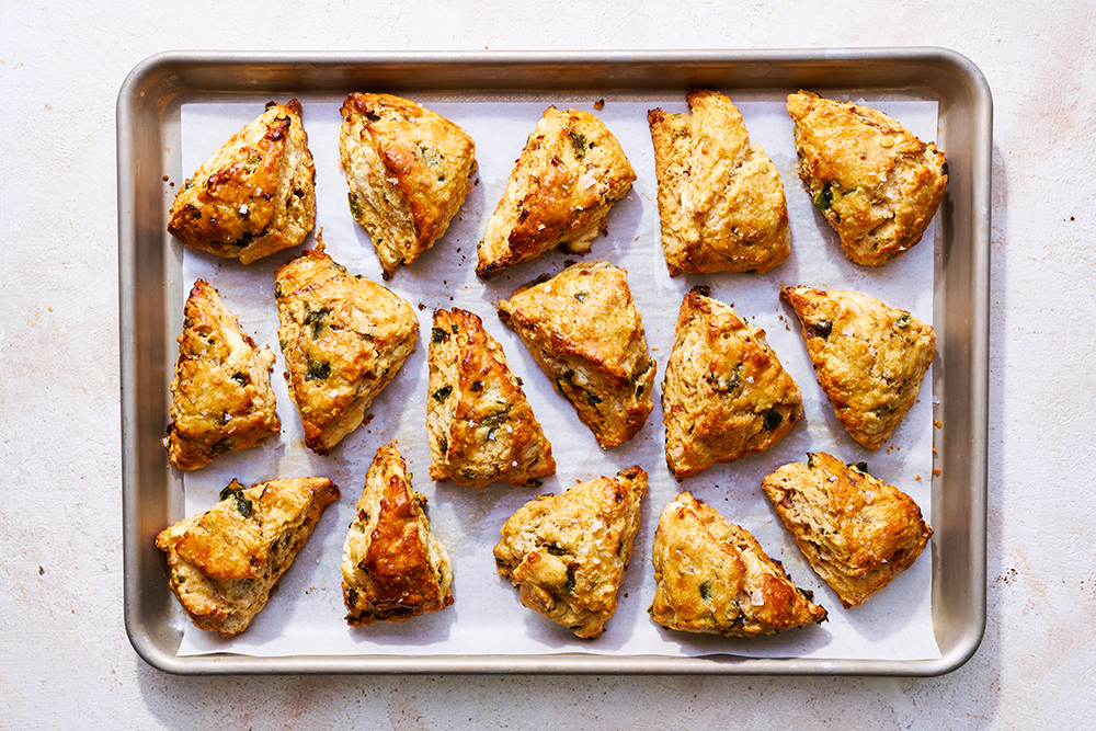 a large baking sheet full of baked savory scones.