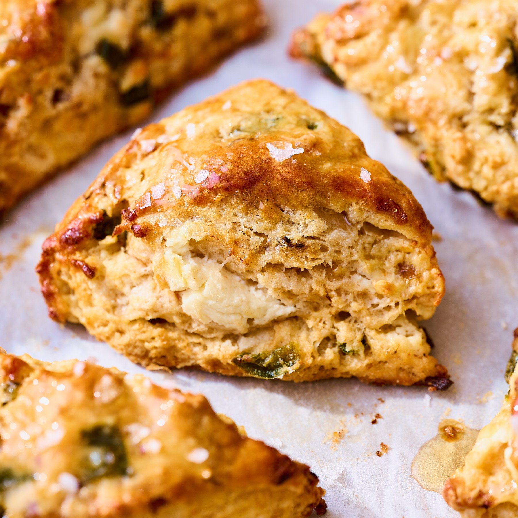 one savory scone up close, so you can see the goat cheese, shallots and jalapenos inside the flaky layers.