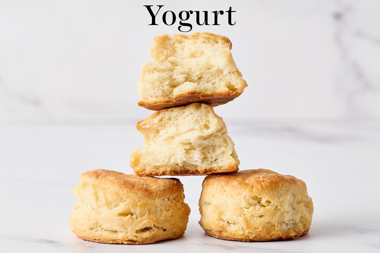 three biscuits made with yogurt instead of buttermilk, stacked in a pyramid, with one torn open so you can see the insides