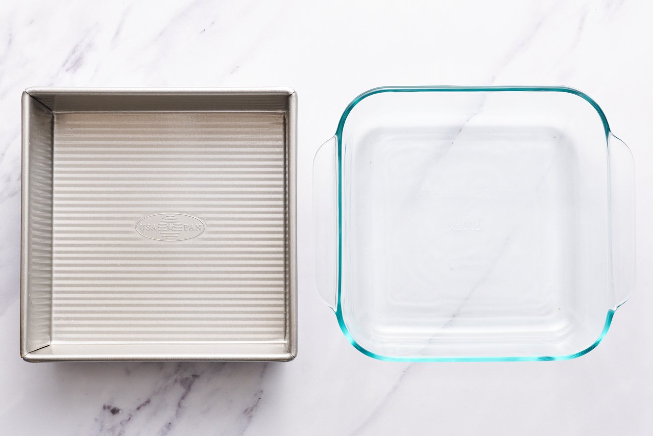 Nordic Ware light-colored metal pan next to Oxo glass pan